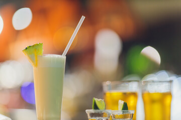 Two shots of tequila and a pair of lemon pieces.