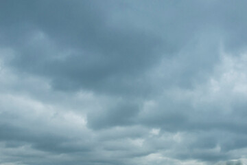 the sky with dense cumulus clouds is dark blue and gray with a texture for the background