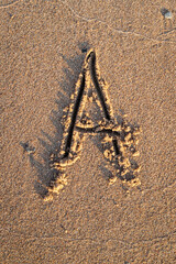 english letters written in the sand