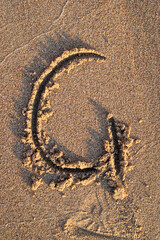english letters written in the sand