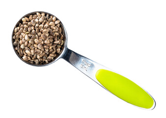 unpeeled hemp seeds in measuring spoon cutout