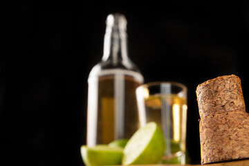 Obraz premium Brazilian drink known as Cachaça, in the foreground a cork and in the background cachaça, a drink from sugar cane. It is used in the preparation of the caipirinha known worldwide, selective focus.