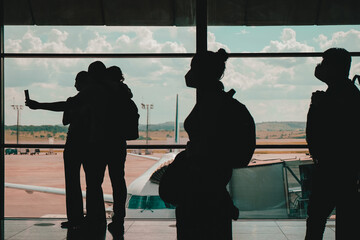 Travelers with face masks at the airport during the global coronavirus pandemic