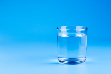 Fresh water in glass on aqua blue background. Part of set.