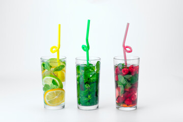 Cocktails isolated on white background. Lemon and lime, mint and raspberries cocktails.