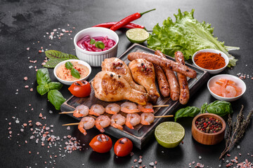 Composition of sausages, chicken, pork and shrimp prepared on grill, as well as vegetables prepared on grill with spices and herbs