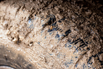 Car wheels in mud. Off road car dirty tire protector. Adventure travel concept background.