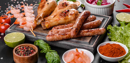Composition of sausages, chicken, pork and shrimp prepared on grill, as well as vegetables prepared on grill with spices and herbs