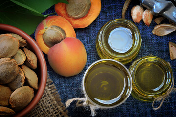 Jars of apricot kernel oil. Apricots, leaves, seeds.