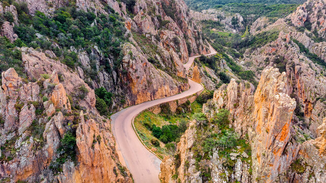 The Calanches de Piana, Drone view of the road between the mountains. The Calanches de Piana are a geological formation of red porphyry of volcanic origin with magmatic rocks. 