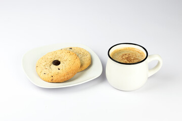 Hot black coffee with foam and sweet chocolate cookies on white background. Part of set.