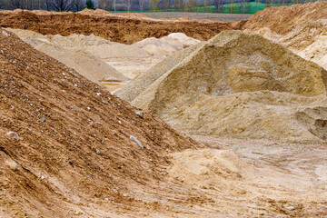 view of a gravel and pebble quarry with piles of materials