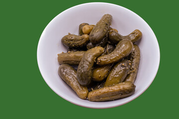 pickled gherkins in a white dish