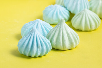 French dessert Meringue on yellow background 