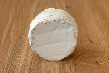 fresh brie cheese, camembert isolated on wooden background