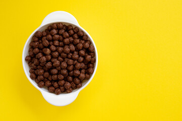 chocolate cereal bowl isolated on yellow background