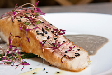 Plate of Huachinanjo loin with beet shoots and black sesame, red snapper fish gourmet cuisine,...