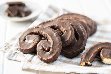 Sweet pastry palmeritas with chocolate icing.