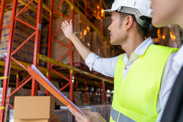 Warehouse worker talking with customer about storage department controlling distribution to the...