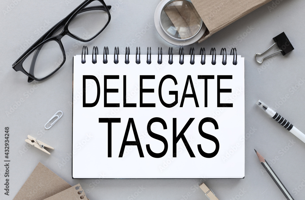 Poster delegate tasks. gray background. text on notepad near glasses with pen and pencil. business layout.
