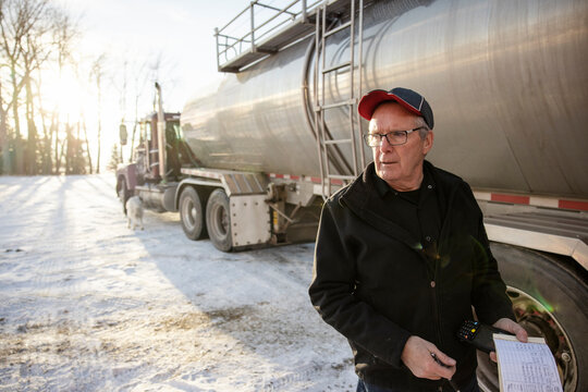 Portrait Of Driver Beside Milk Tanker Truck