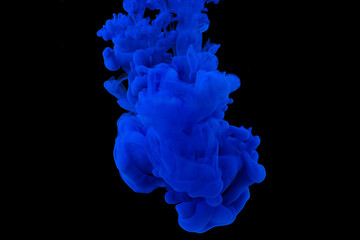 explosion of acrylic blue paint in clear water. Black background