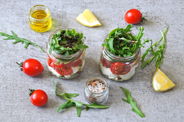 Salads in jars. Healthy salad with feta and arugula. Summer snack to go.