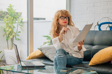 business woman working at home with online computer and documents