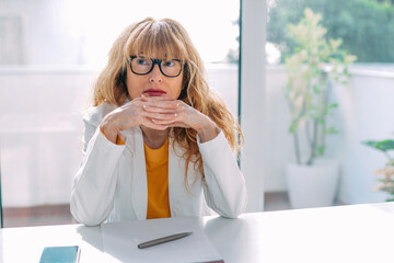 business woman at the desk pensive