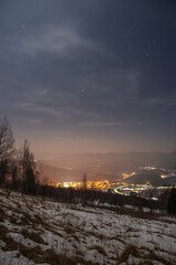 Beautiful panorama of the night city in the mountains in winter