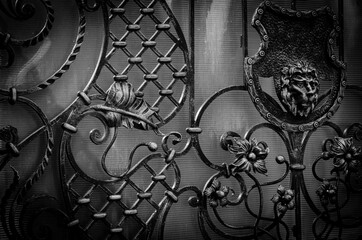 Beautiful decorative forged elements of a metal gate. Modern trends of wrought iron gates