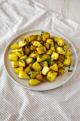 Homemade Roasted Potatoes with Mustard Seeds on a Plate, low angle view.
