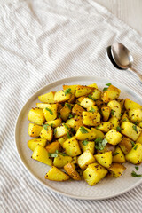 Homemade Roasted Potatoes with Mustard Seeds on a Plate, side view. Copy space.