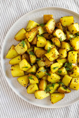 Homemade Roasted Potatoes with Mustard Seeds on a Plate, overhead view. Flat lay, top view, from above.