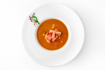 Delicacy spicy cream seafood soup with crab meat. Banquet festive dishes. Gourmet restaurant menu. White background.