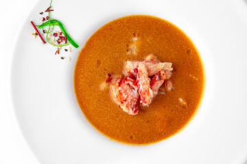 Delicacy spicy cream seafood soup with crab meat. Banquet festive dishes. Gourmet restaurant menu. White background.