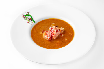 Delicacy spicy cream seafood soup with crab meat. Banquet festive dishes. Gourmet restaurant menu. White background.