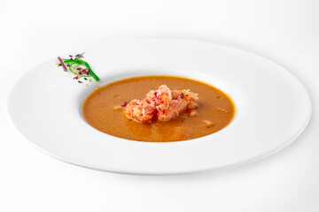 Delicacy spicy cream seafood soup with crab meat. Banquet festive dishes. Gourmet restaurant menu. White background.