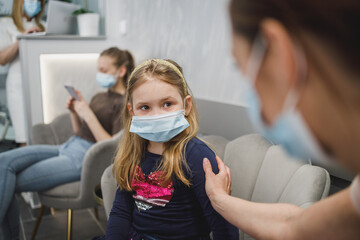 Mom Consoling Her Little Daughter At Hospital Waiting Room