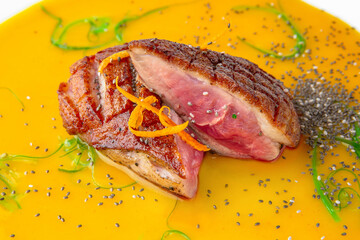 Medium Rare duck breast in mango sauce with chia seeds and chuka seaweed. Banquet festive dishes....