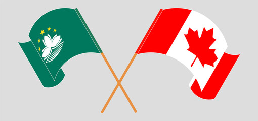 Crossed and waving flags of Macau and Canada