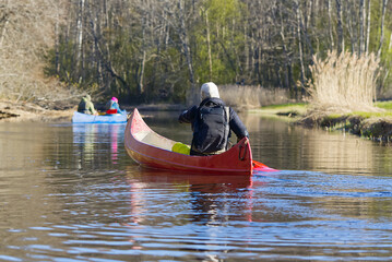 Family canoeing on the river in the early morning, dawn time. Joint pastime, entertainment, outdoor recreation, acquaintance with nature. Family quality time. Soomaa, Estonia