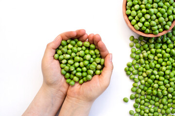 peas in women's hands on white background.