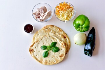 Barbecue chicken vegetable flat bread pizza, at home cooking, simple, healthy food background, mediterranean diet. Photo concept food, close-up, flat lay, copy space