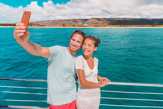 Cruise selfie vacation happy tourists taking photo with phone on boat trip ferry. Interracial couple Asian woman, Caucasian man. - Powered by Adobe
