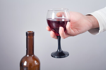 Man holding glass of red wine.
