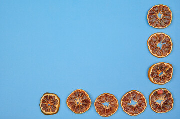 dried red oranges on a blue background with place to insert