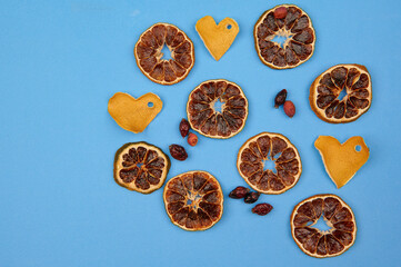 oranges, rose hips and zest in the form of hearts on a light background