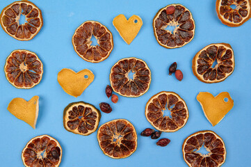 zest hearts, oranges, dried rose hips and on a blue background