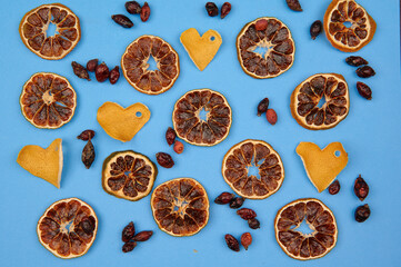orange slices, zest hearts, rose hips and on a blue background